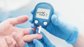 Doctor checking blood sugar level with glucometer. Treatment of diabetes concept.